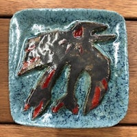 a ceramic plate with a bird on it